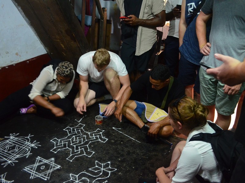 Trying Floral patterns or Kolam in Kochi Sightseeing Tour